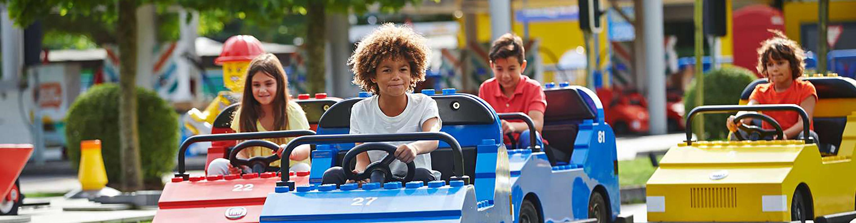 Children riding miniature cars at Legoland Driving school, Windsor