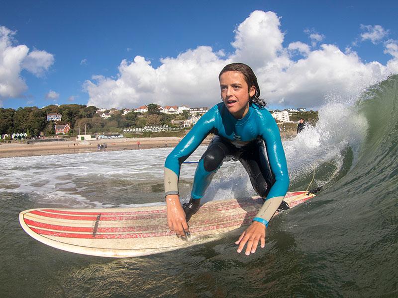 Girl surfing at Swansea Bay