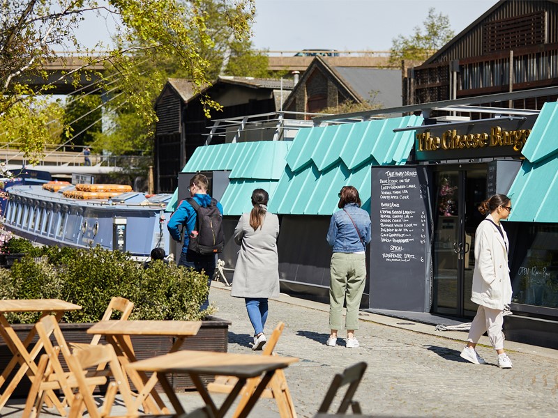 Customers queuing outside the Cheese Barge restaurant in London Paddington