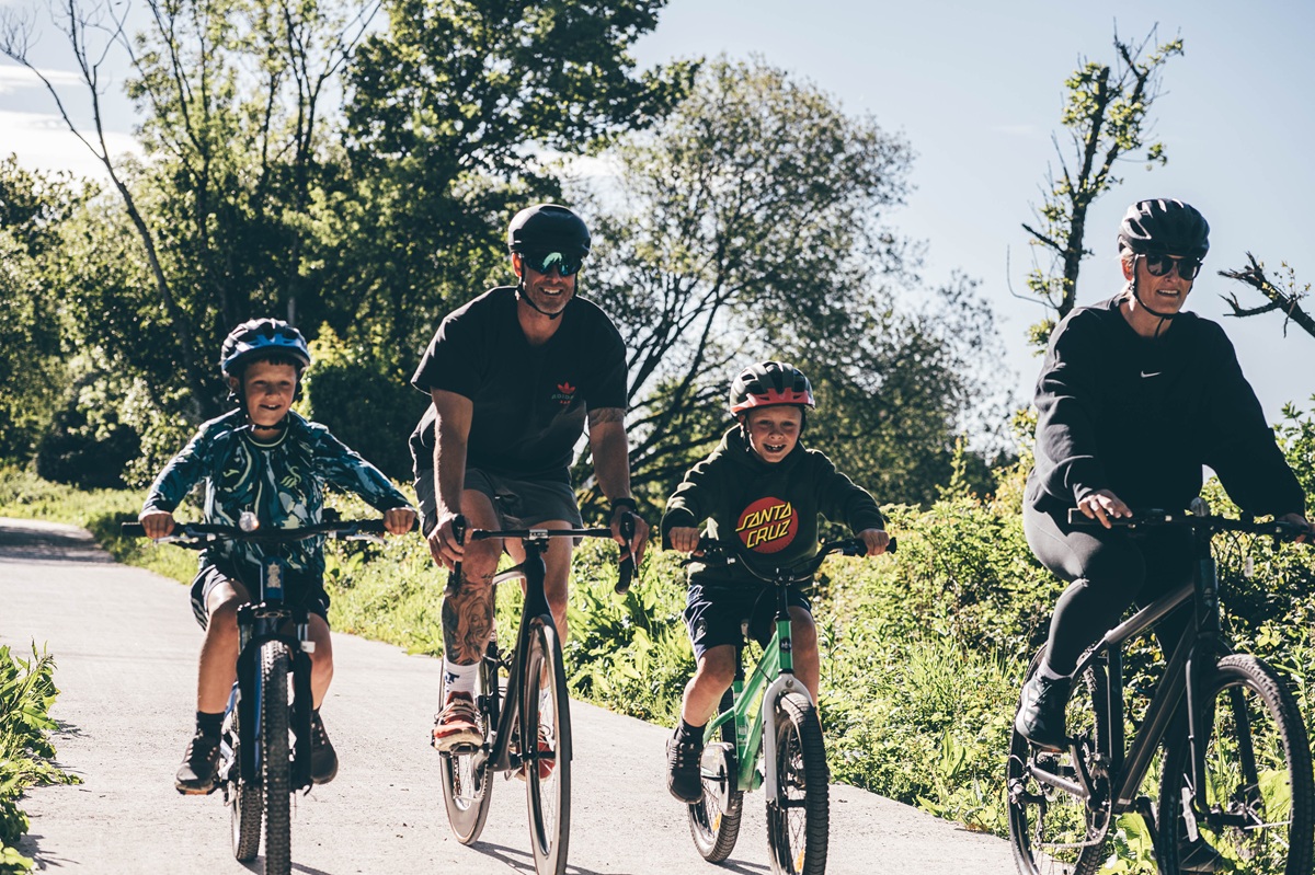 A family enjoying a cycle ride with young children.