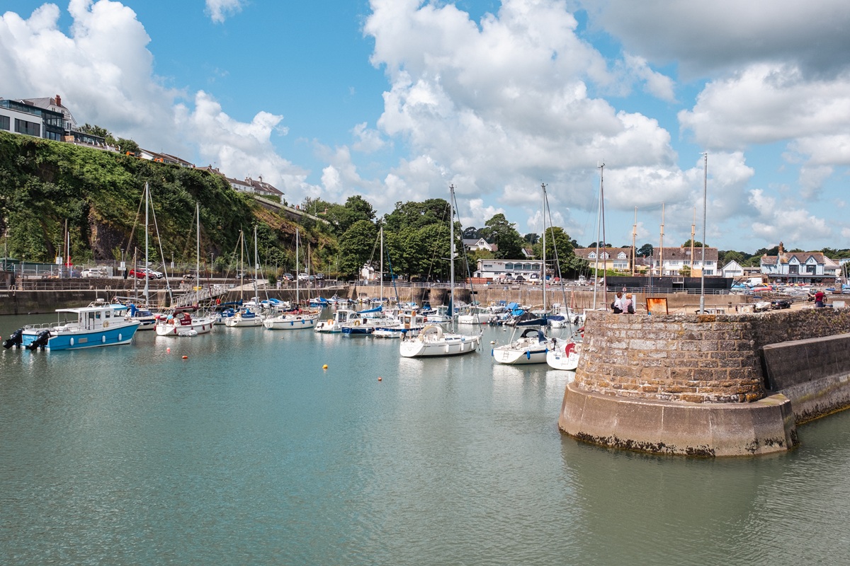 Saundersfoot harbour on a clear day with boats at dock