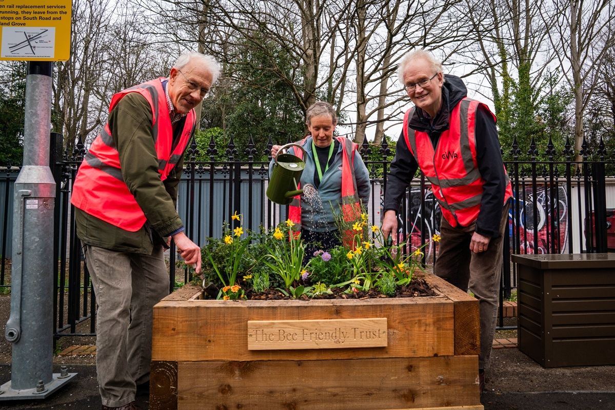 GWR station volunteers planting up the 100th Bee Friendly Trust planter at Redland station, while also celebrating 10 years of the Trust.