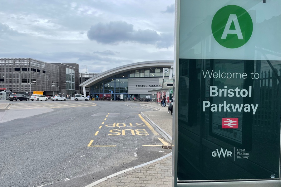 Photo of the exterior of Bristol Parkway station, with a welcome sign in the foreground