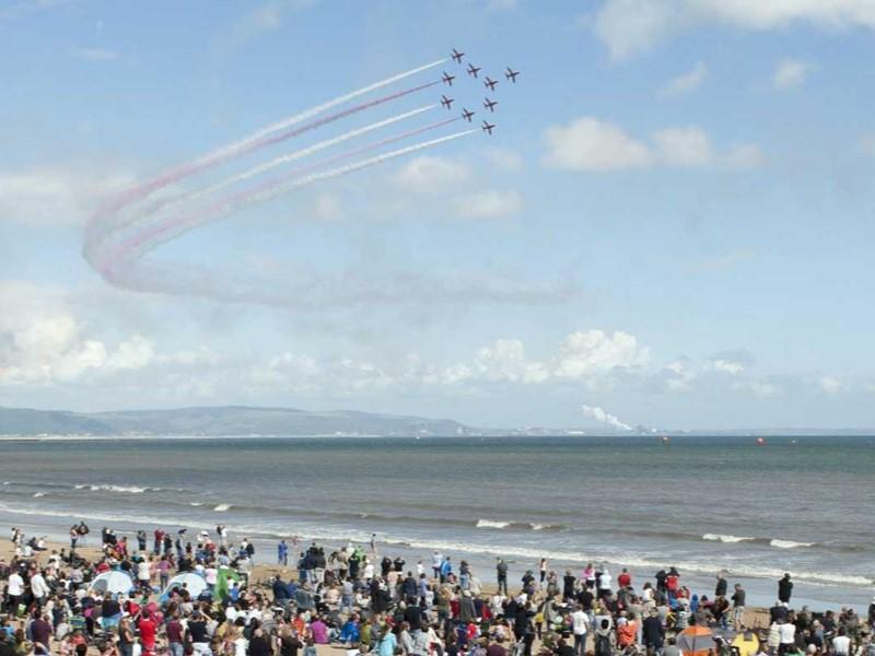 Photo of The Red Arrows in formation, flying over Swansea Bay for the Wales Airshow