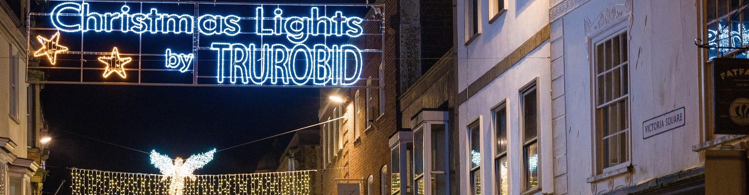 A Christmas light display over Victoria Square in Truro, showing the words 'Christmas Lights by TRUROBID'