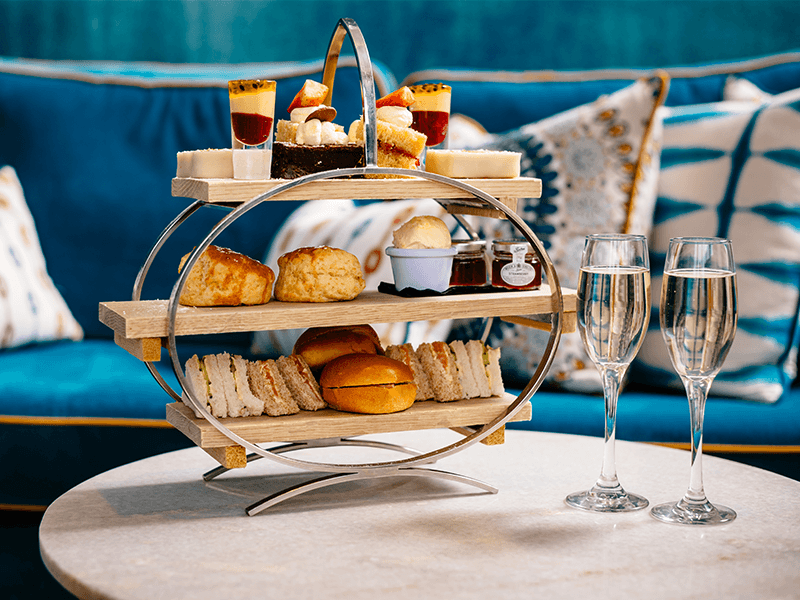 Sandwiches, champagne and cakes displayed - afternoon tea offering at the Greenbank Hotel in Cornwall