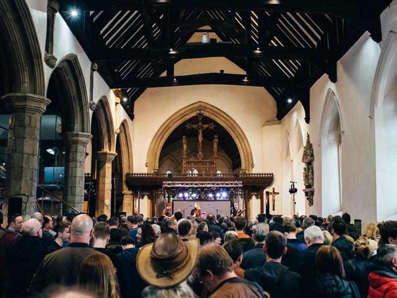 Band playing in a church at Are You Listening festival