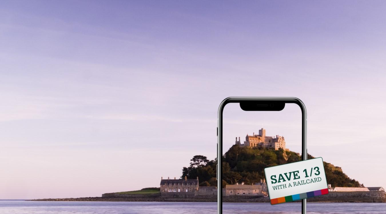 St Michael's Mount in Cornwall, with a mobile device overlaid and a tag saying 'Save 1/3 with a Railcard'.