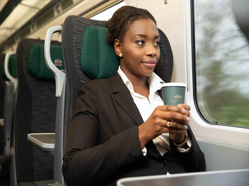 Passenger sitting in GWR's First Class carriage looking out of window