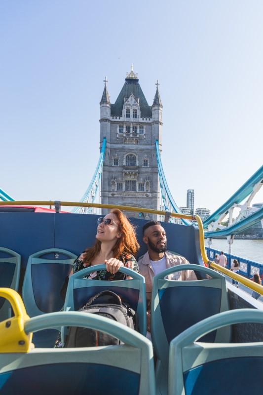 A couple enjoying the sights of London on the Tootbus sight-seeing tour.