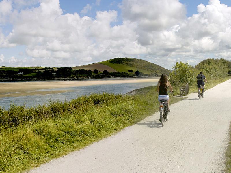 Couple cycling in along the Cornish coast