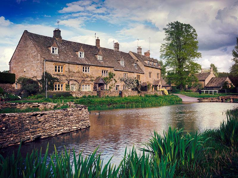 Cottages on the riverbank in the Cotswolds
