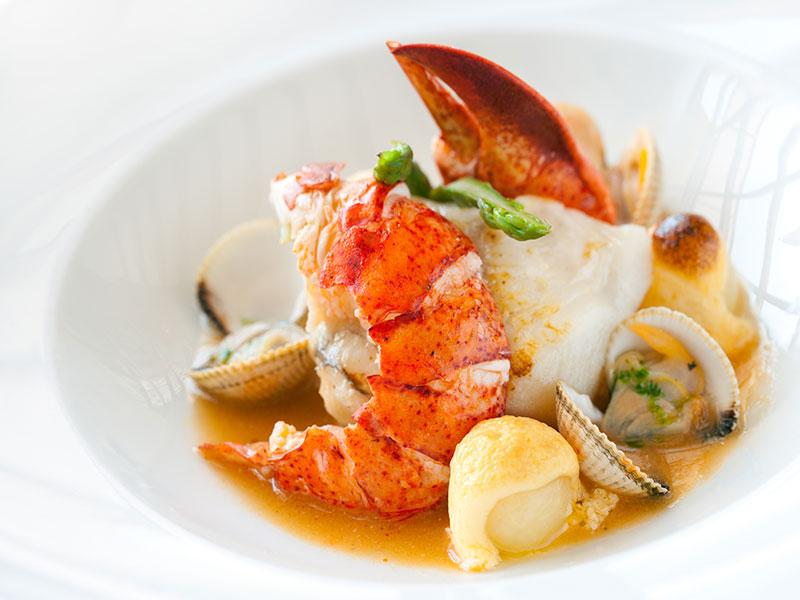 plate with lobster tail and other seafood
