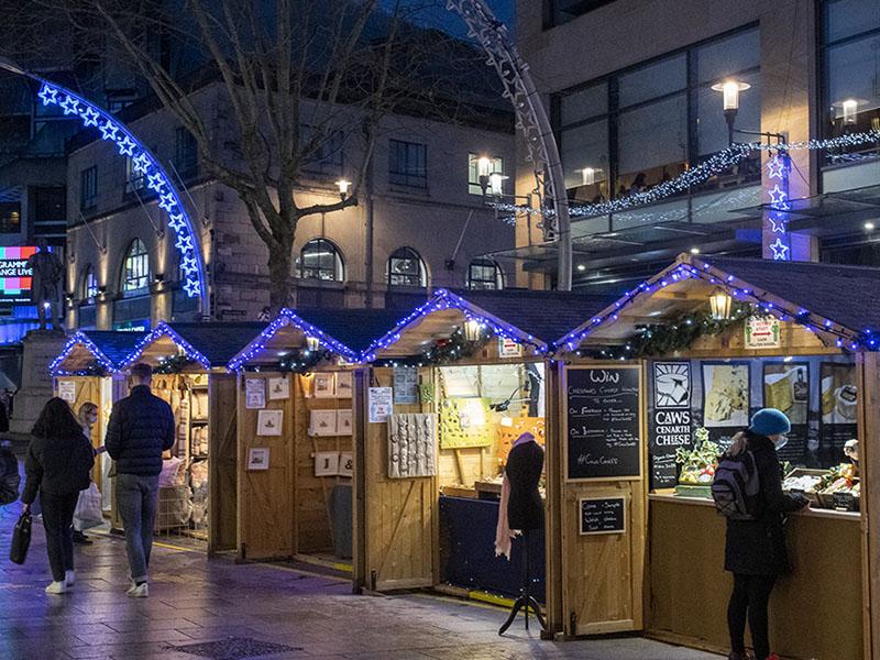 Booths with visitors at Cardiff Christmas market