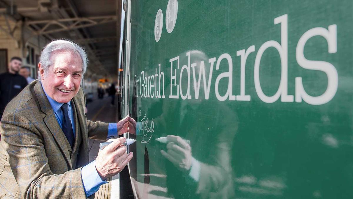 Sir Gareth Edwards signing his name on a GWR IET