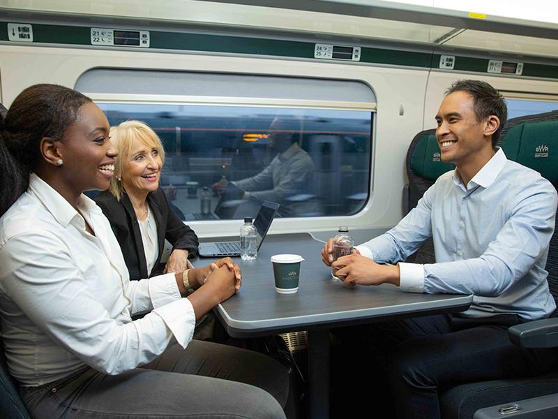 Three customers sitting at a First Class table in GWR's First Class carriage
