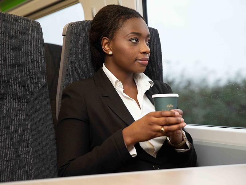 Passenger on GWR train sitting at table looking out of window